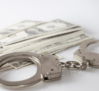Handcuffs beside cash