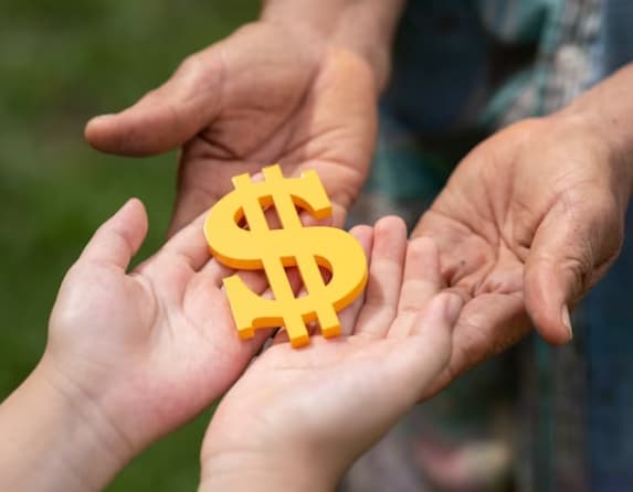 Hands holding a gold dollar sign